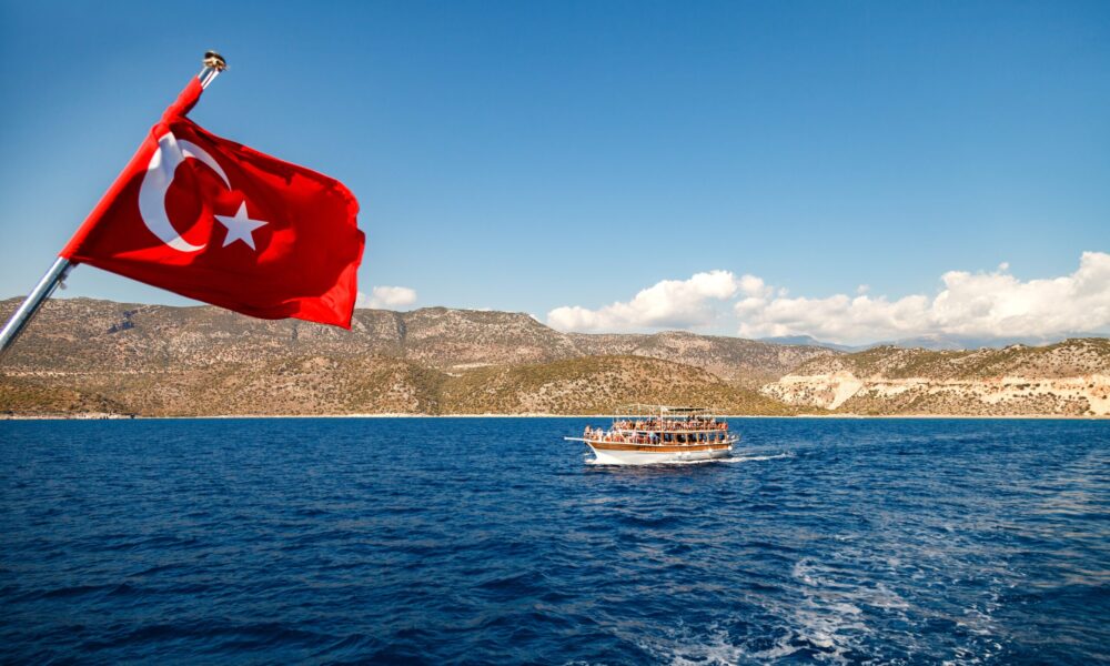 Yacht under the Turkish flag in the Mediterranean. Beautiful view of Kemer mountains
